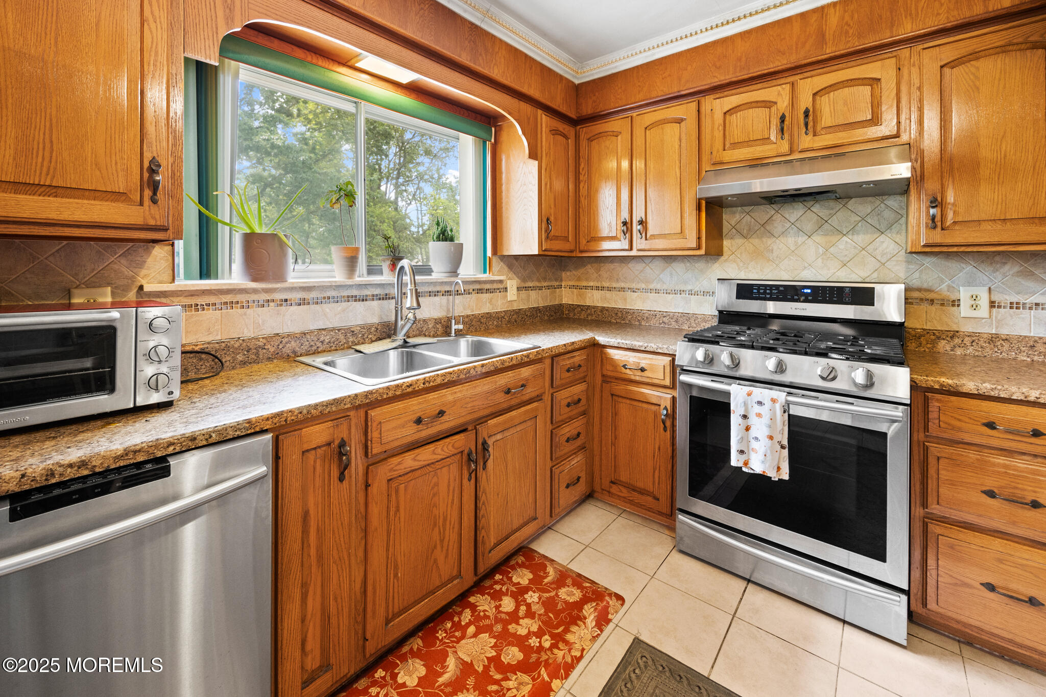 117 Greymoor Road Howell, NJ 07731 - Photo 11 of 32 a kitchen with stainless steel appliances granite countertop a stove sink and cabinets