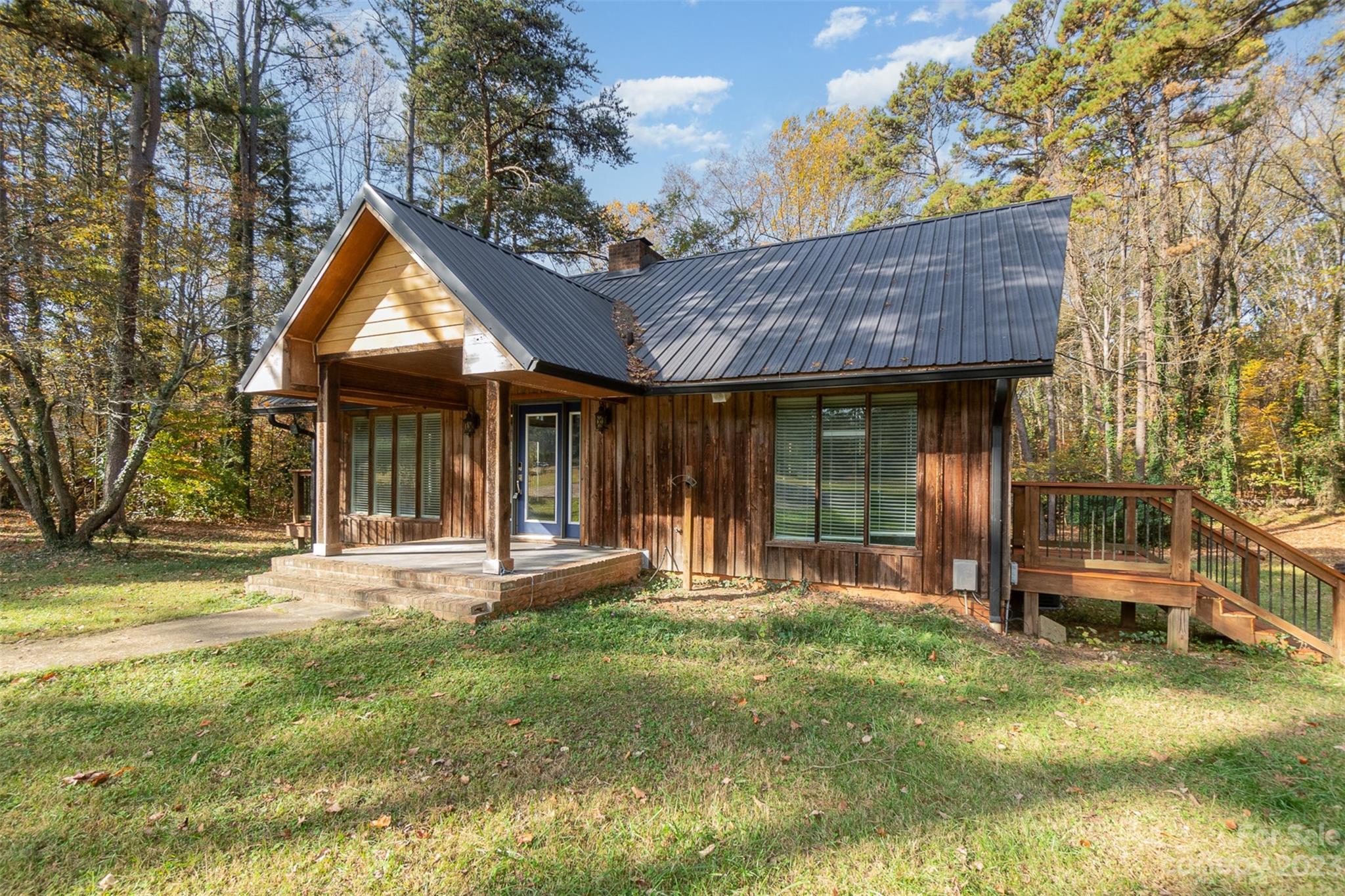 6745 Alanbrook Road Charlotte, NC 28215 - Photo 1 of 28 a view of a house with backyard porch and sitting area