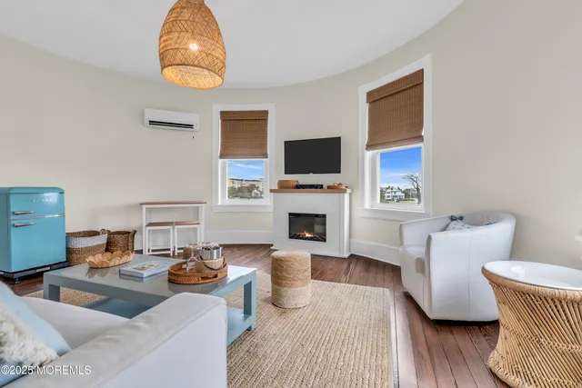 a living room with furniture a fireplace and a flat screen tv
