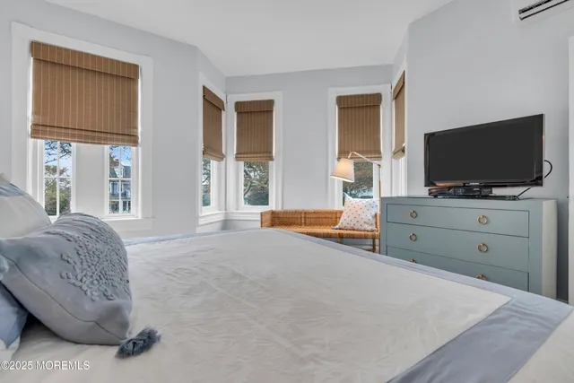 a bedroom with furniture and flat screen tv