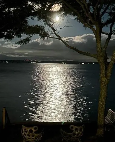 a living room with furniture and floor to ceiling windows