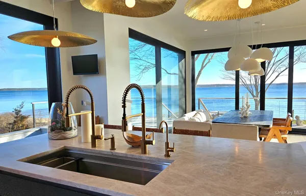 a kitchen with stainless steel appliances granite countertop a sink and a stove