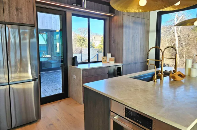 a kitchen with stainless steel appliances granite countertop a stove and a sink