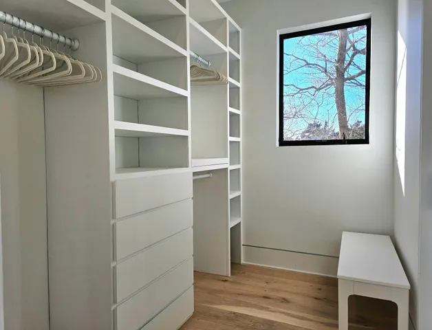 a bathroom with a double vanity sink mirror and shower