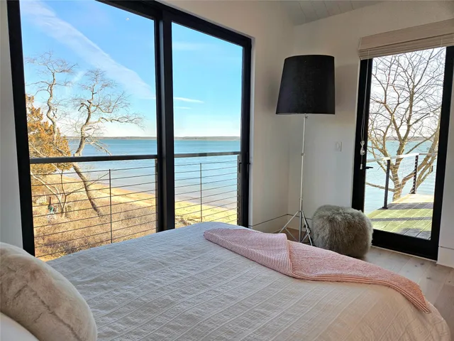 a bedroom with a large bed and a large window