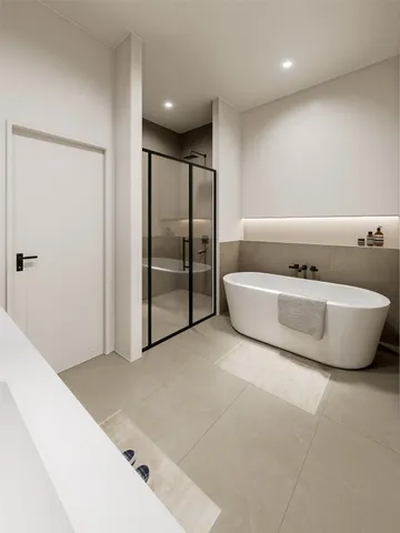 a bathroom with a tub sink and mirror