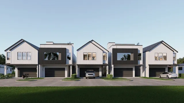 a view of a big house with couches and a fire pit next to a yard