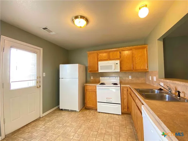 a kitchen that has a sink and a stove