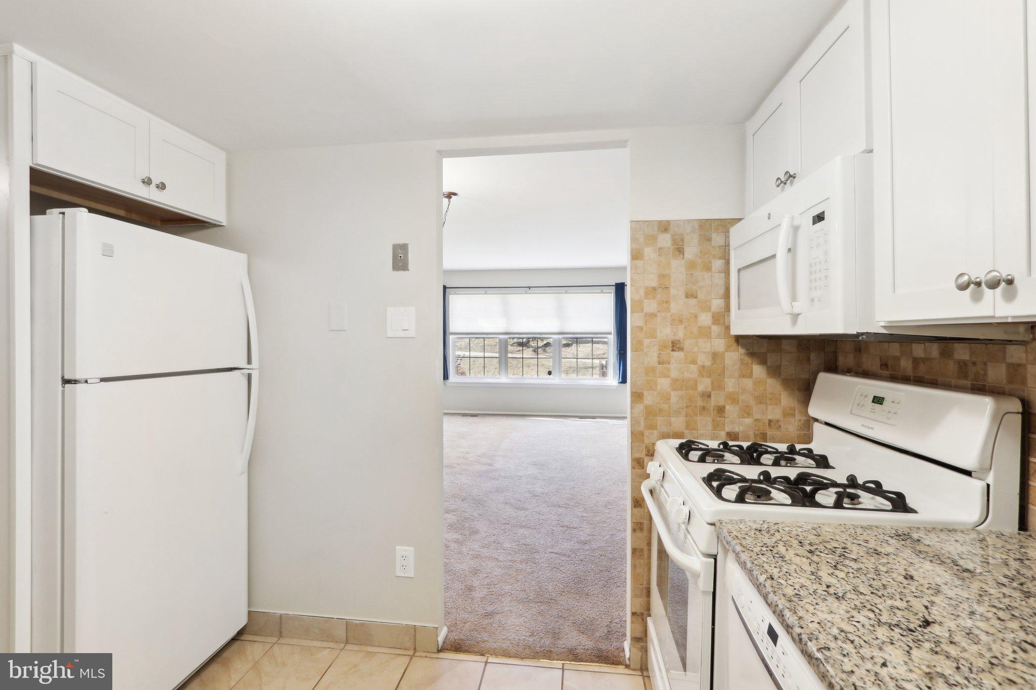 467 Old Forge Crossing Devon, PA 19333 - Photo 13 of 34 a kitchen with a refrigerator and a stove