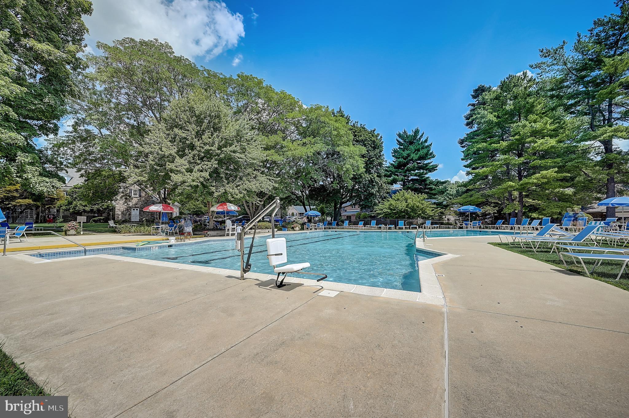 467 Old Forge Crossing Devon, PA 19333 - Photo 27 of 34 a view of swimming pool with outdoor seating and trees in the background