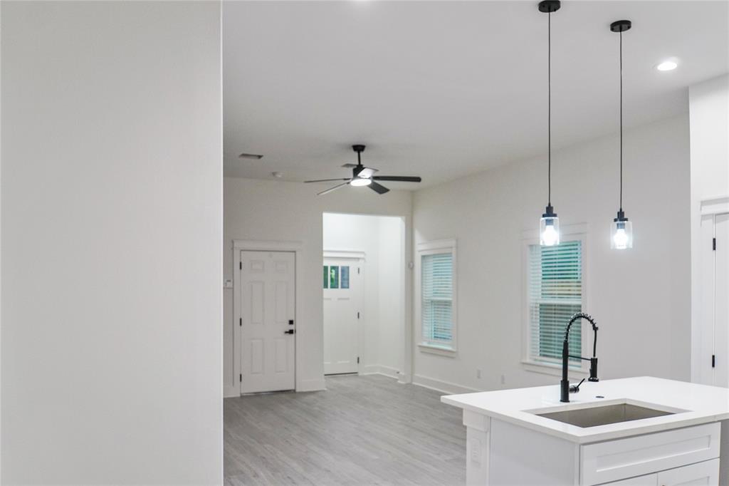 2642 Sutton Street Dallas, TX 75210 - Photo 11 of 12 a bathroom with a sink a light fixture and a mirror