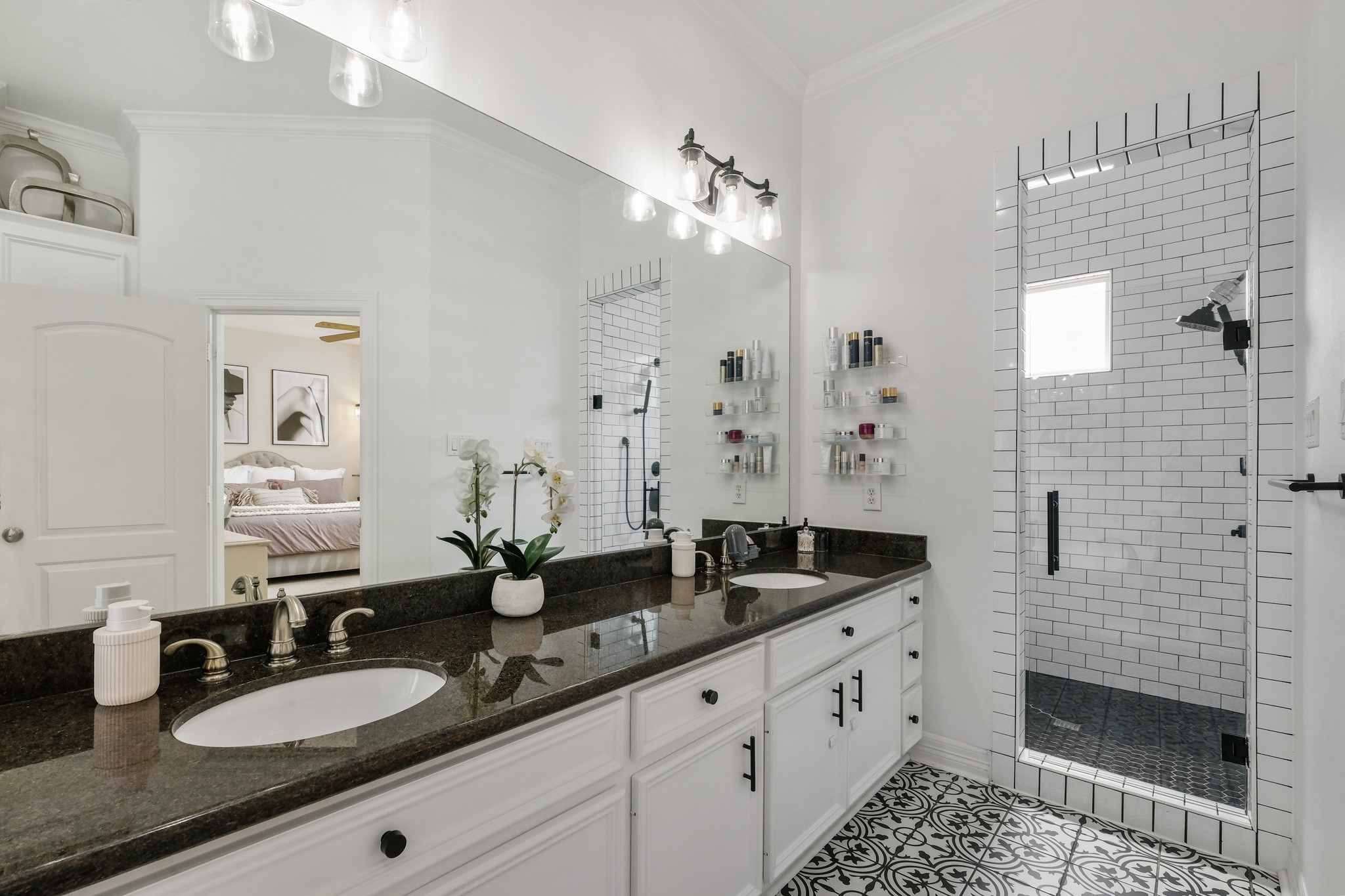 933 West 17th Street Houston, TX 77008 - Photo 9 of 19 This incredible Primary Bathroom boasts a beautiful private shower with a gorgeous tiling, granite countertops, wooden cabinetry and double sinks.
