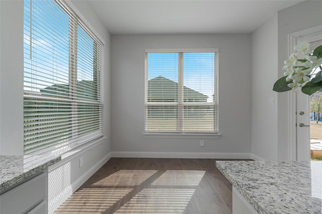 4028 Yellow Jasmine Lane Heath, TX 75126 - Photo 13 of 38 Unfurnished dining area featuring dark wood-type flooring and baseboards