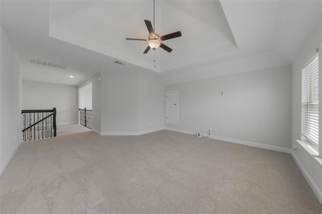 4028 Yellow Jasmine Lane Heath, TX 75126 - Photo 23 of 38 Unfurnished room featuring a tray ceiling, visible vents, light carpet, and baseboards
