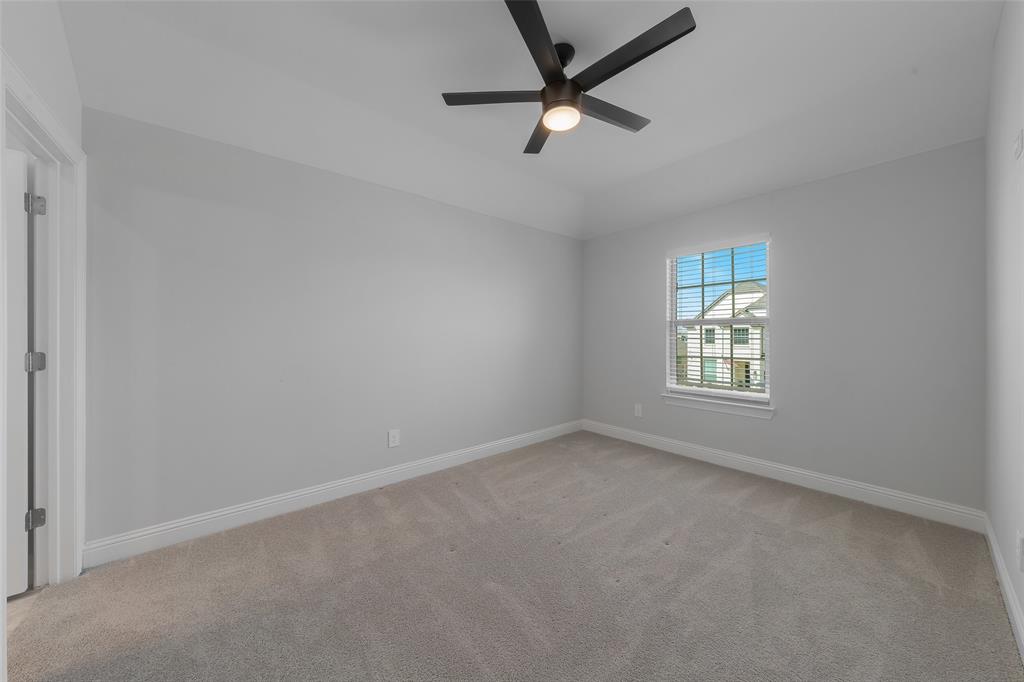 4028 Yellow Jasmine Lane Heath, TX 75126 - Photo 25 of 38 Bedroom featuring light carpet, ceiling fan, lofted ceiling, and baseboards