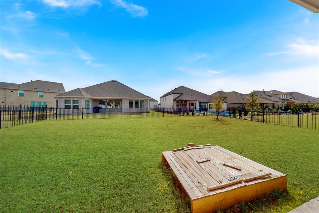 4028 Yellow Jasmine Lane Heath, TX 75126 - Photo 31 of 38 View of community with a residential view, a fenced backyard, and a lawn