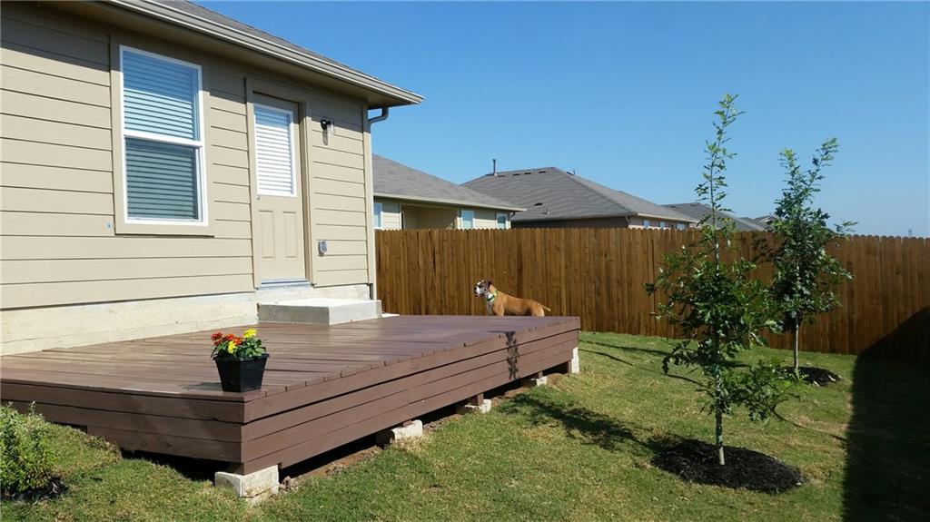 185 Voss Kyle, TX 78640 - Photo 23 of 26 a wooden bench sitting in front of a house