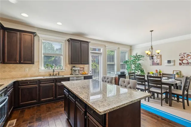 a kitchen with granite countertop a sink and a stove