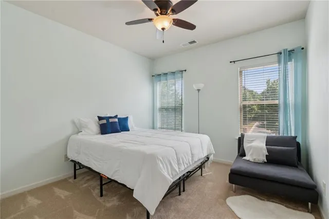 a bedroom with a bed couch and a window