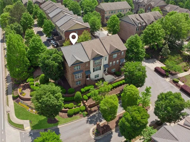 an aerial view of a house with a yard and outdoor seating