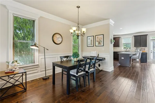 a view of a dining room with furniture window and wooden floor
