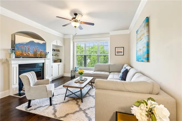 a living room with furniture fireplace and a large window