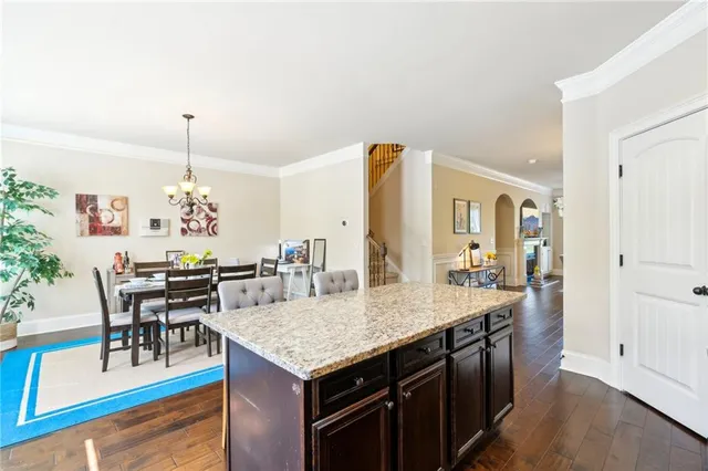 a kitchen with center island table and chairs
