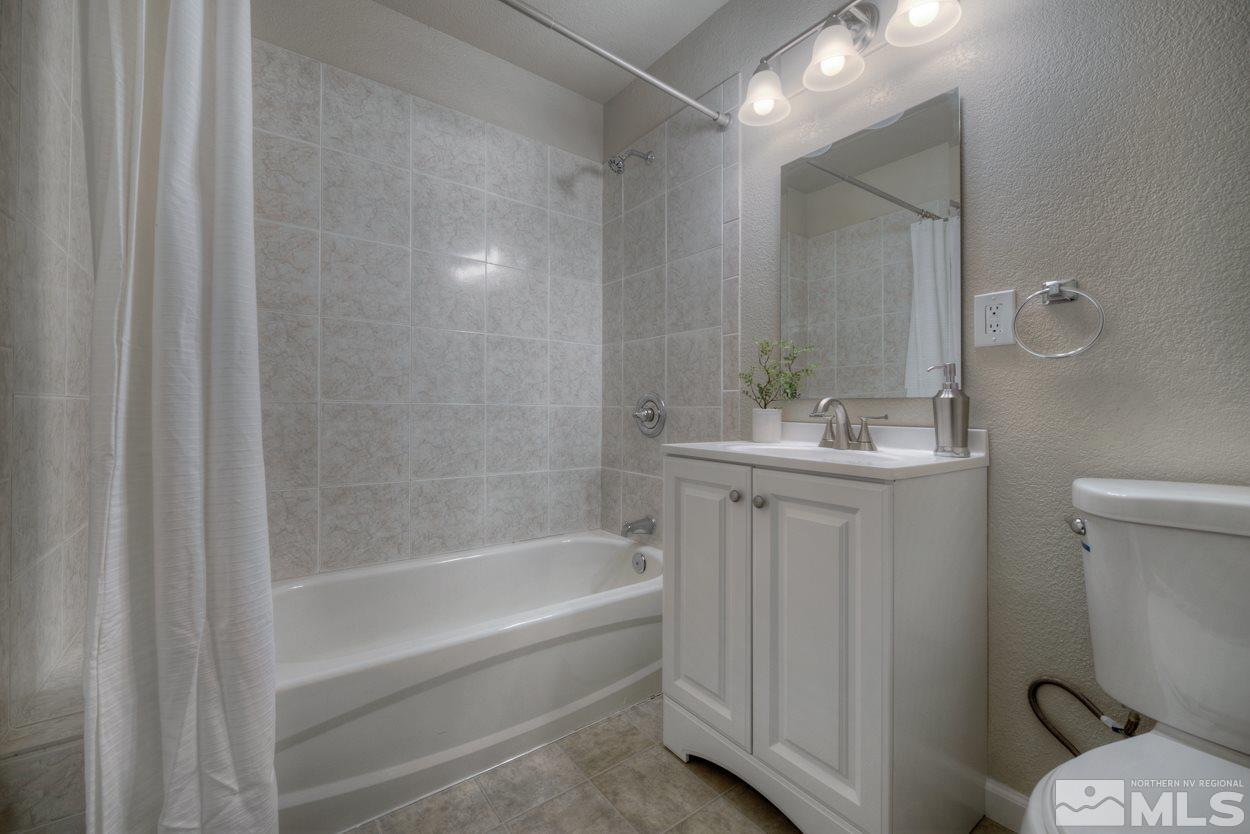 2150 Sutro Street, Unit A Reno, NV 89512 - Photo 13 of 25 a bathroom with a sink a toilet and shower