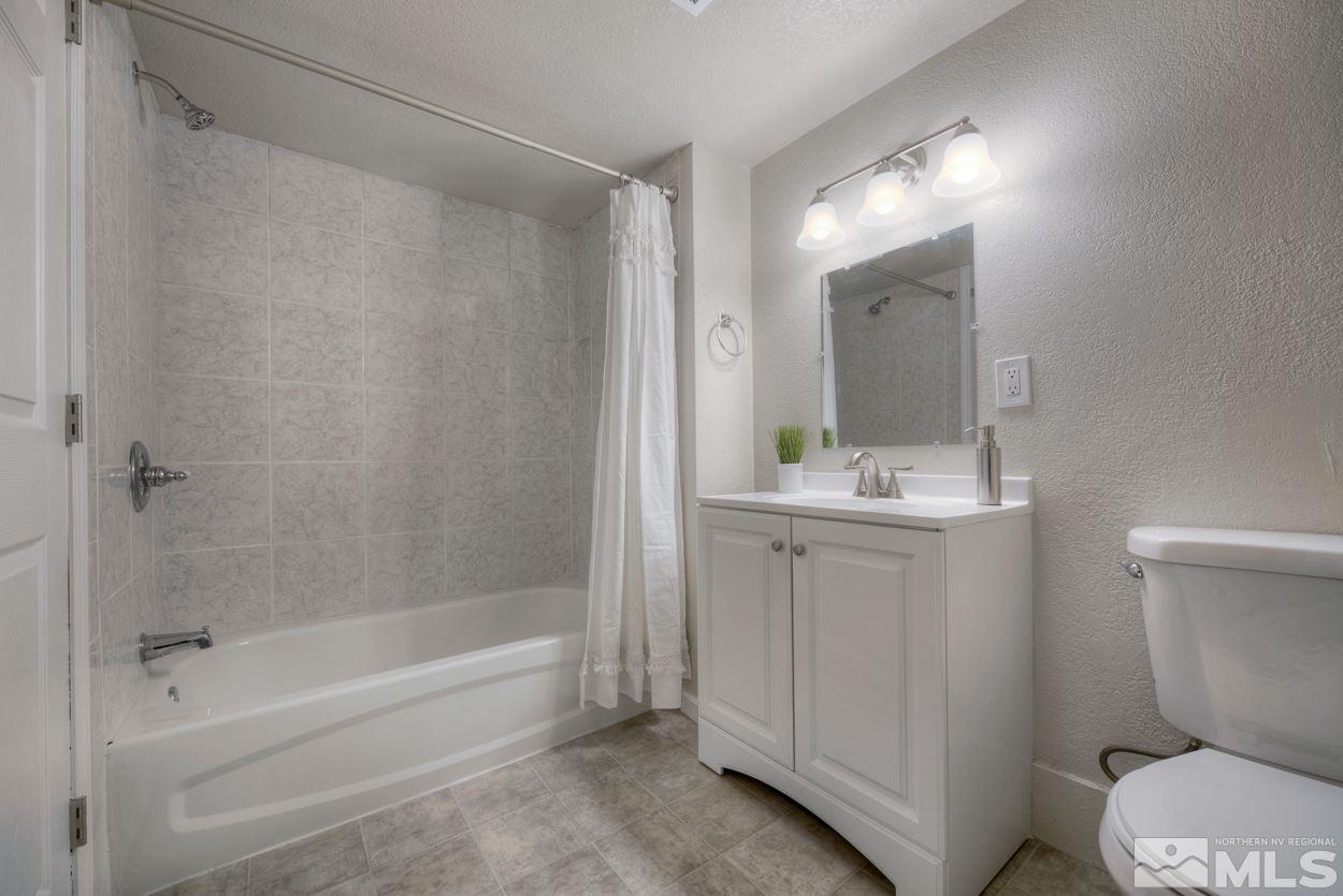 2150 Sutro Street, Unit A Reno, NV 89512 - Photo 18 of 25 a bathroom with a toilet a sink and a bathtub