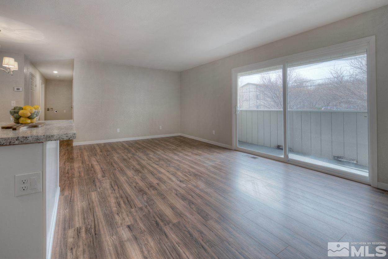 2150 Sutro Street, Unit A Reno, NV 89512 - Photo 7 of 25 an empty room with wooden floor and windows