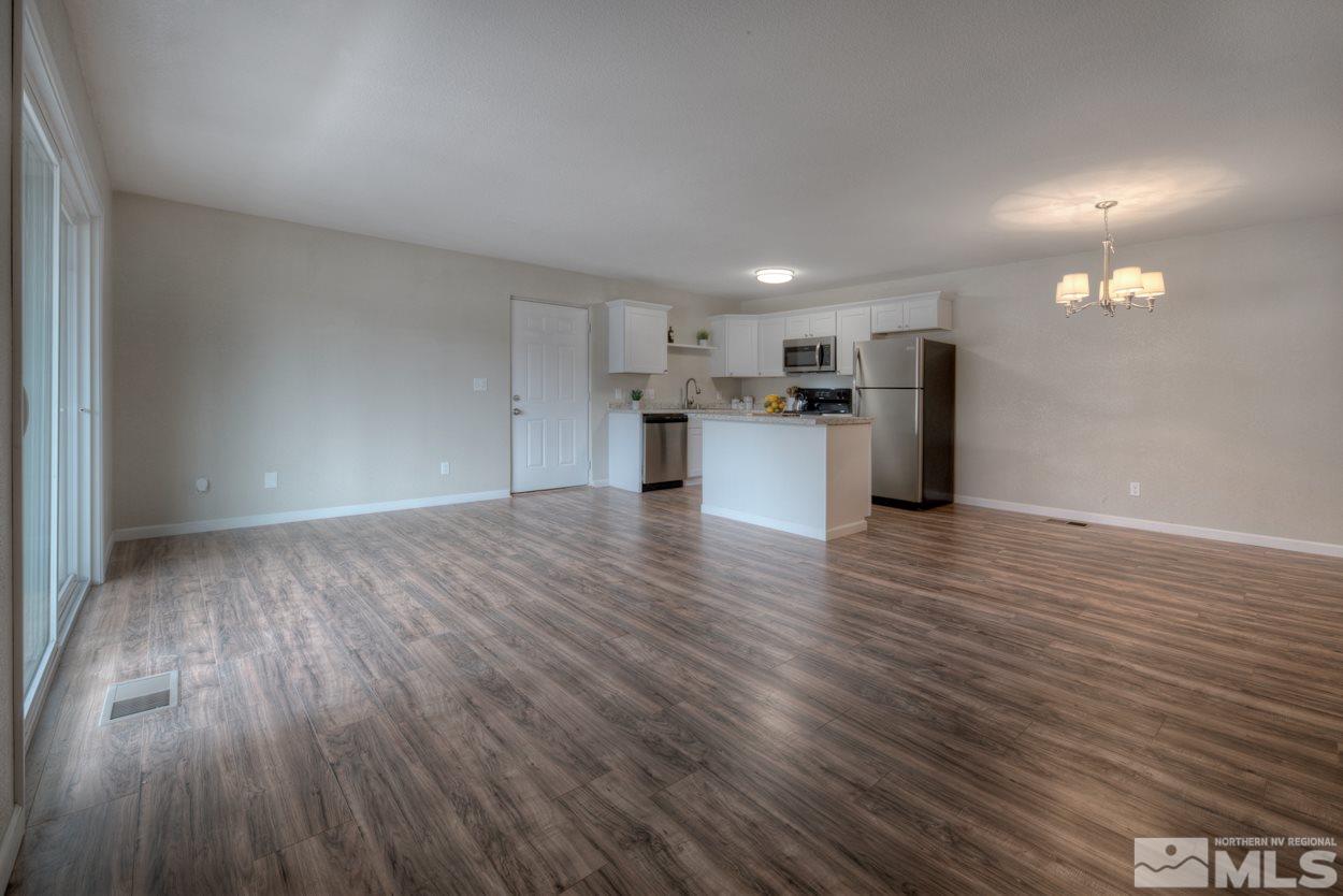 2150 Sutro Street, Unit A Reno, NV 89512 - Photo 8 of 25 a view of a kitchen with a sink and a refrigerator
