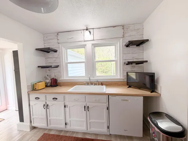 a kitchen with cabinets appliances and a window