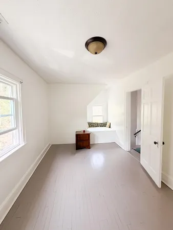 an empty room with a empty space and window