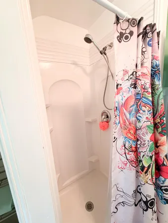a bathroom with a bathtub and shower