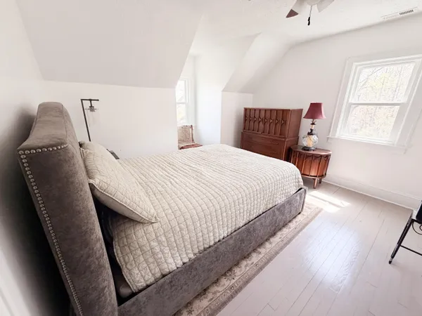 a bedroom with a bed and window