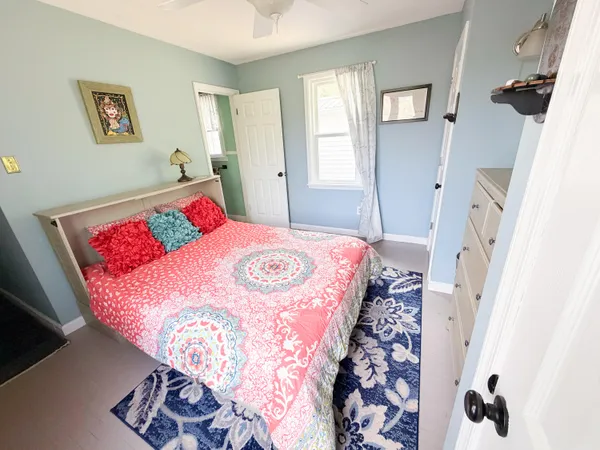 a bedroom with a bed and a dresser