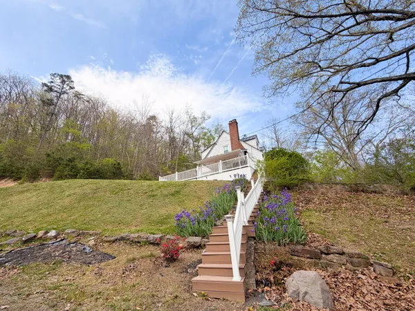 a aerial view of house with yard and large trees