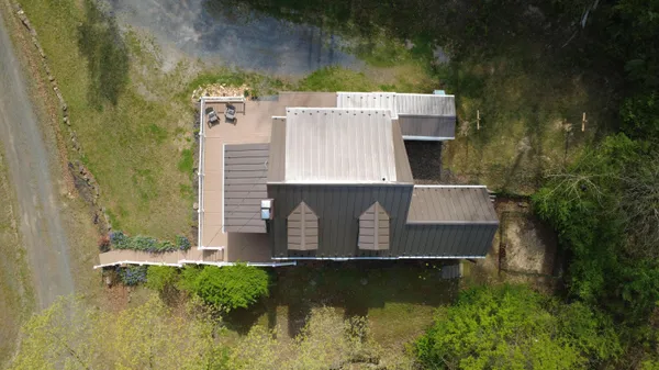 an aerial view of a house with a yard