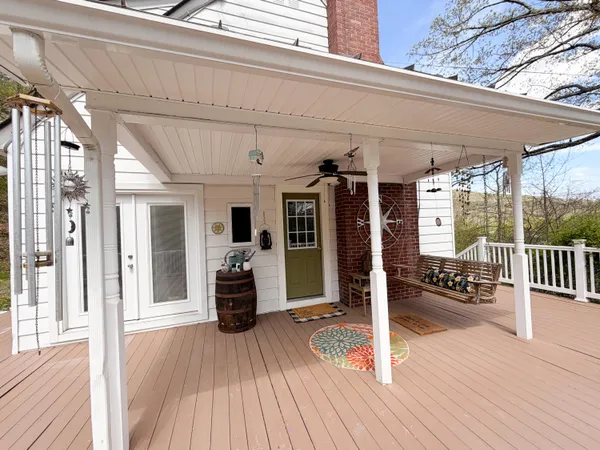 a view of a patio with table and chairs in wooden floor