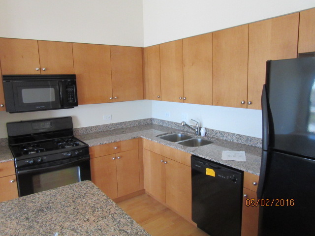 4848 North Sheridan Road, Unit 802 Chicago, IL 60640 - Photo 4 of 11 a kitchen with stainless steel appliances granite countertop a sink stove and refrigerator