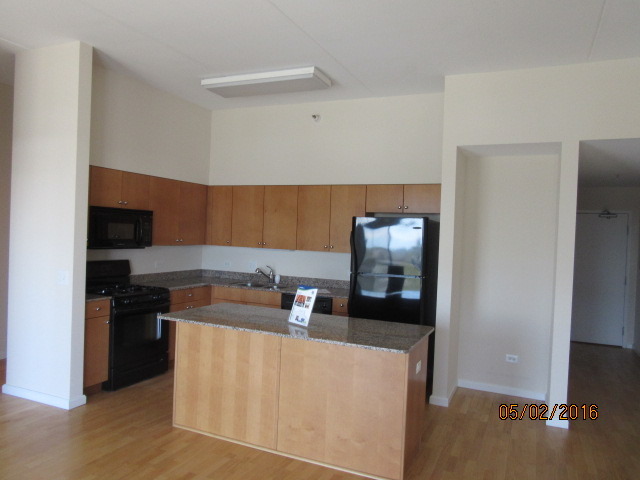 4848 North Sheridan Road, Unit 802 Chicago, IL 60640 - Photo 7 of 11 a kitchen with stainless steel appliances granite countertop a refrigerator and a stove