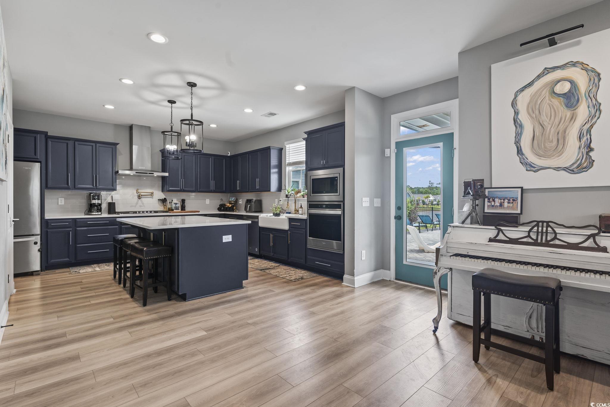 375 Bumble Circle Murrells Inlet, SC 29576 - Photo 12 of 40 Kitchen featuring a center island, wall chimney ex