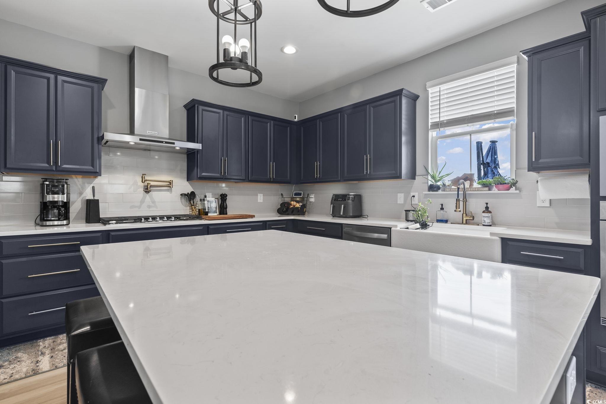 375 Bumble Circle Murrells Inlet, SC 29576 - Photo 15 of 40 Kitchen with sink, a center island, wall chimney r