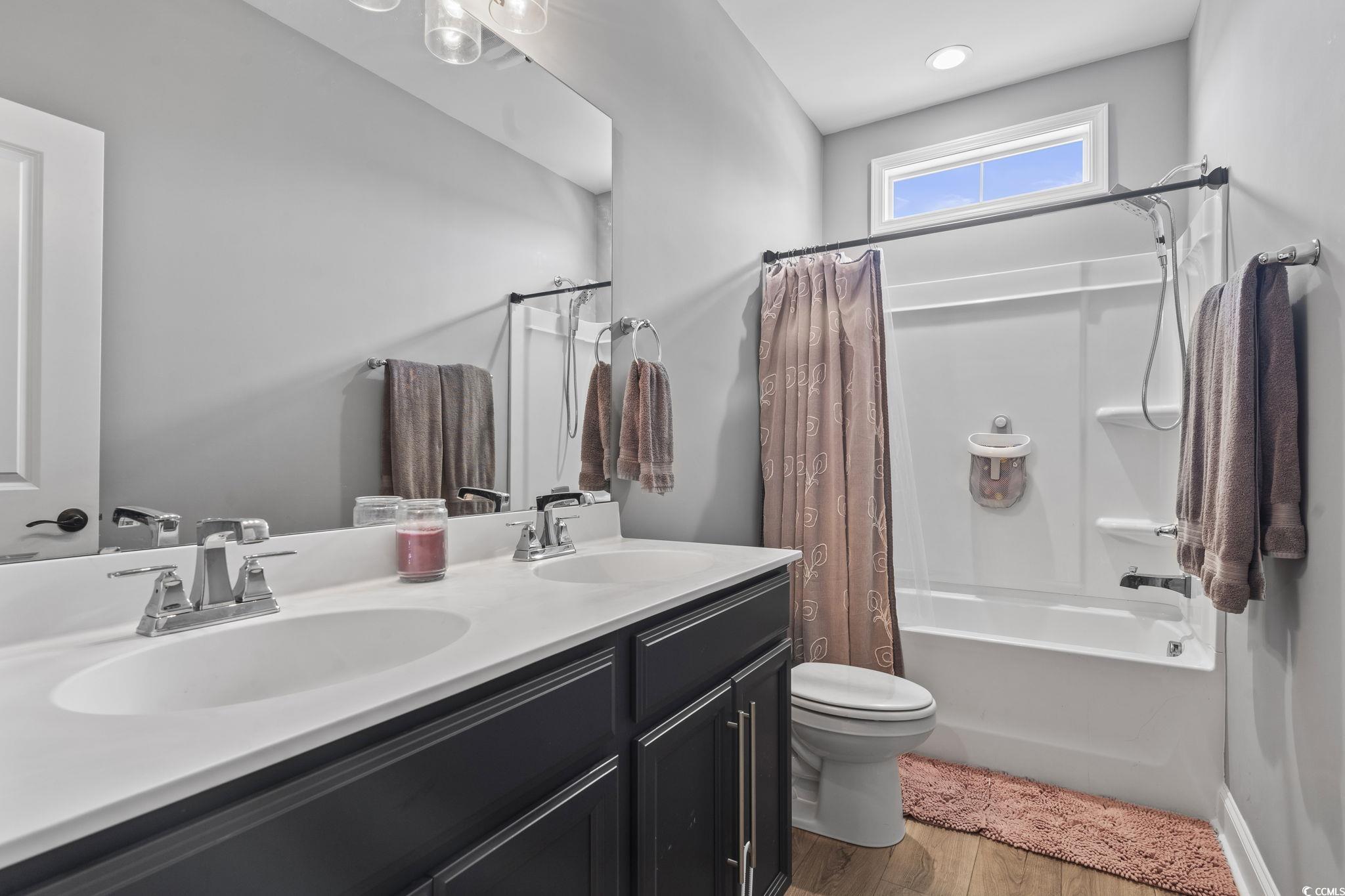 375 Bumble Circle Murrells Inlet, SC 29576 - Photo 24 of 40 Full bathroom with toilet, wood-type flooring, van
