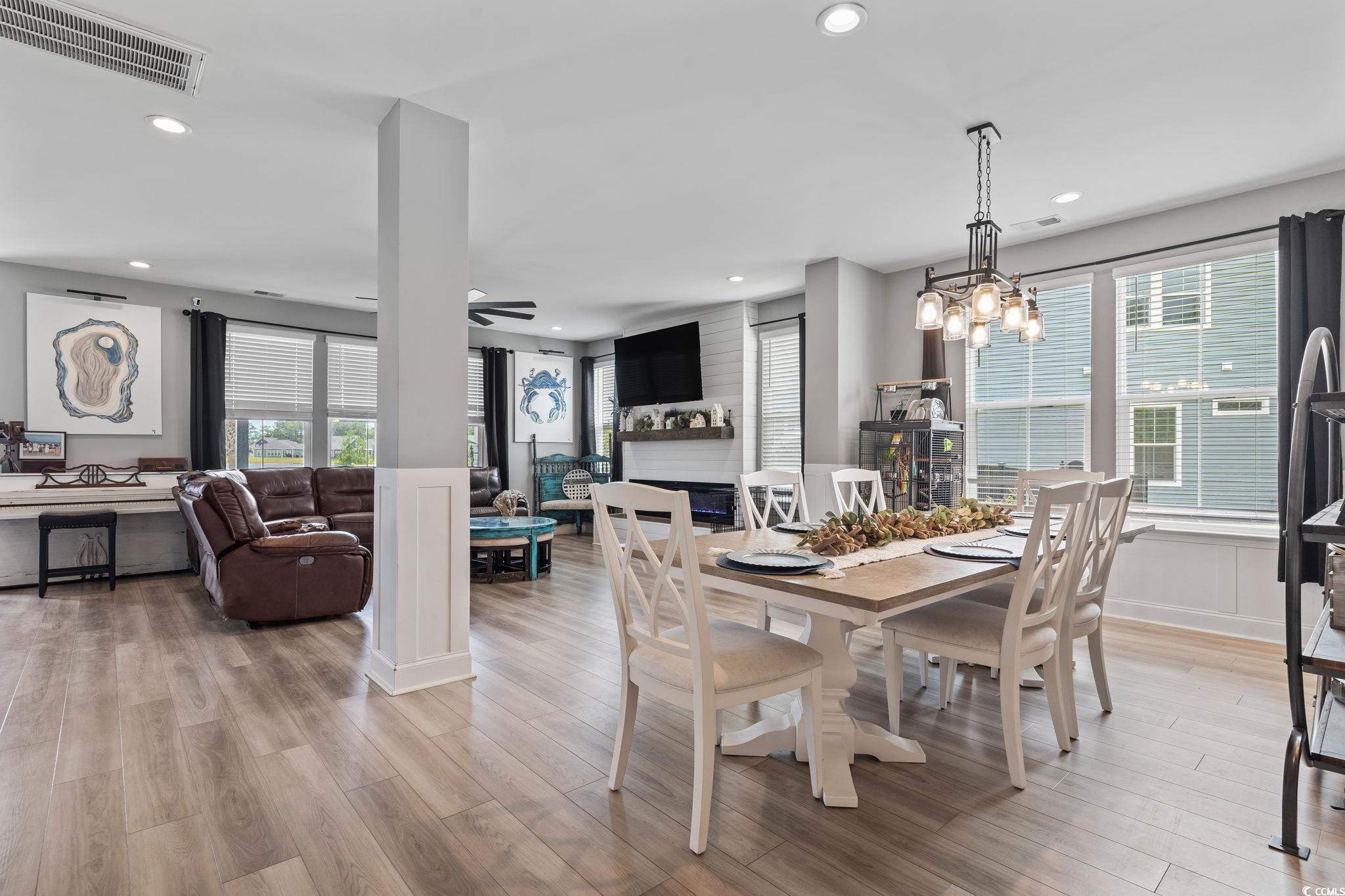 375 Bumble Circle Murrells Inlet, SC 29576 - Photo 8 of 40 Dining area with a fireplace, light hardwood / woo