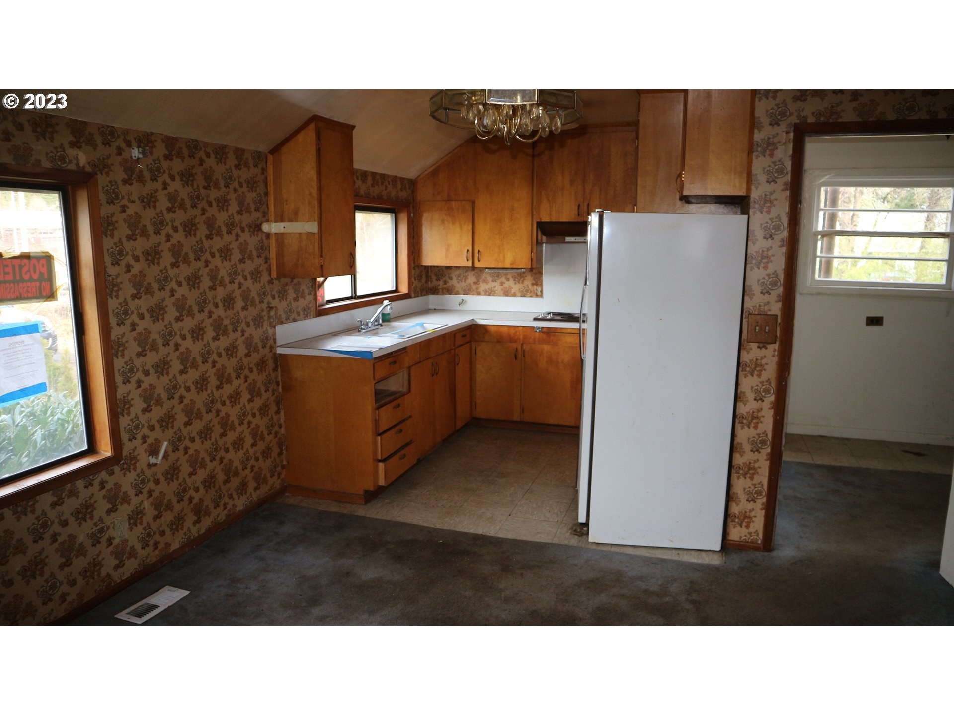 19480 Southeast Sunnyside Road Damascus, OR 97089 - Photo 3 of 16 a kitchen with a refrigerator and a sink