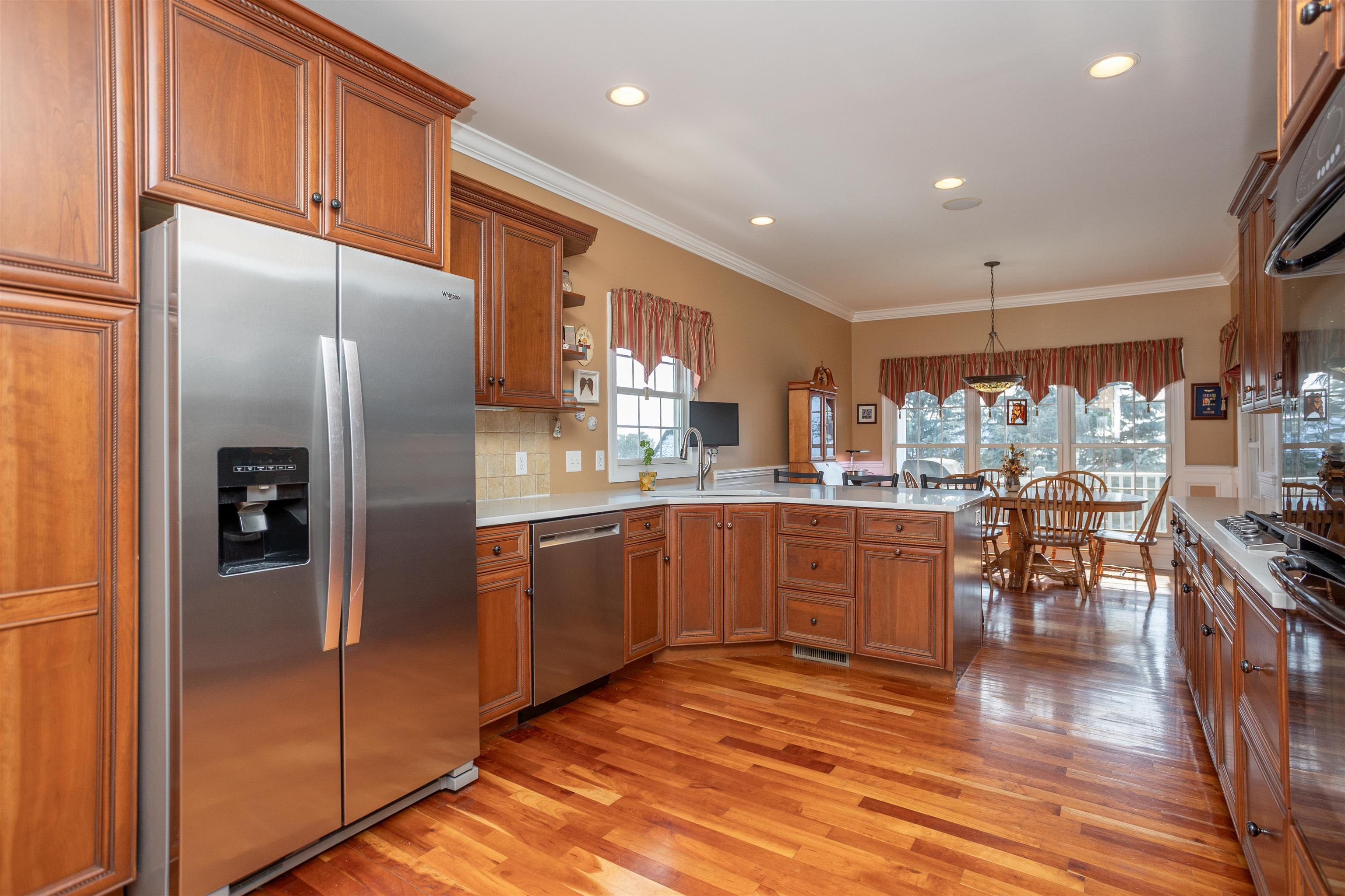 203 Keswick Circle Dayton, VA 22821 - Photo 14 of 73 a kitchen with stainless steel appliances granite countertop a refrigerator a sink a stove and a refrigerator with wooden floor