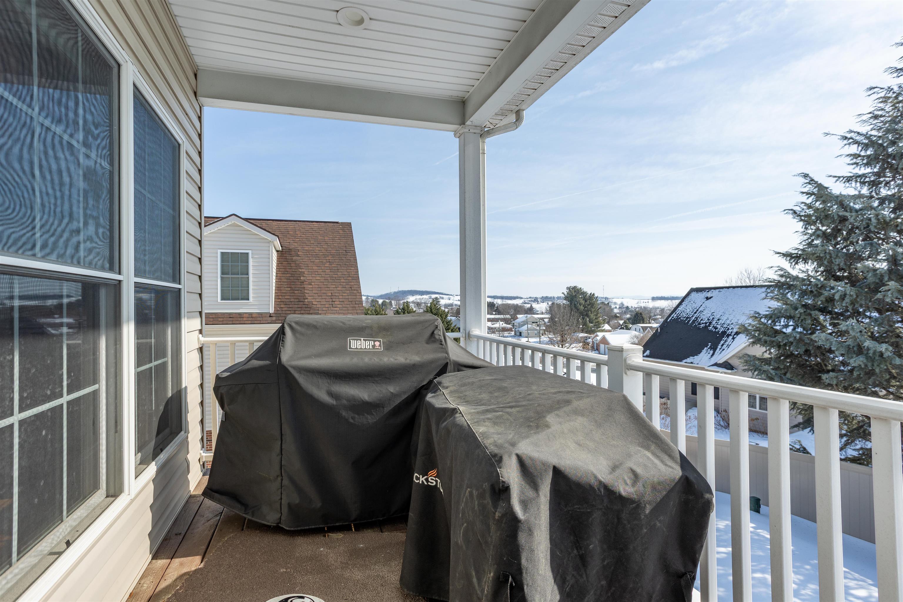 203 Keswick Circle Dayton, VA 22821 - Photo 68 of 73 a view of a balcony with chair and wooden fence