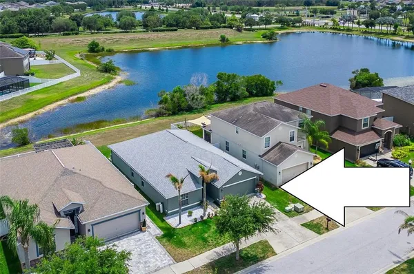 an aerial view of a house with garden space and lake view