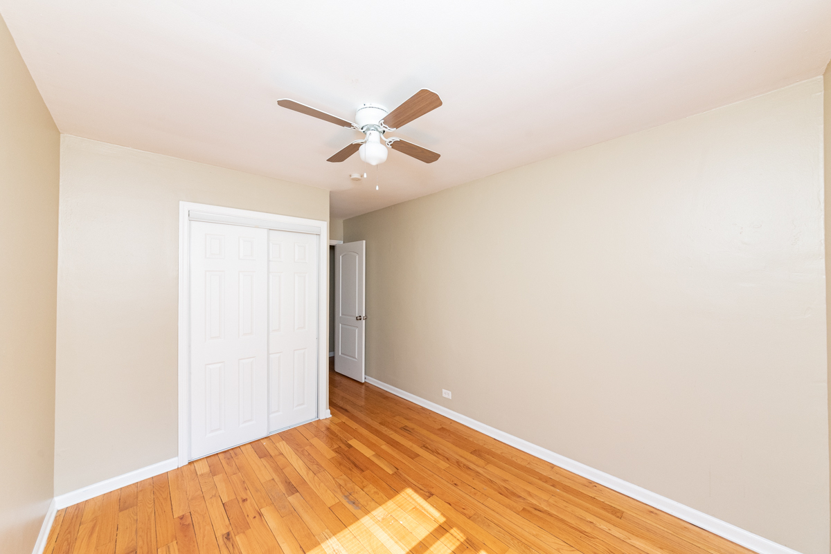 225 Custer Avenue, Unit 3 Evanston, IL 60202 - Photo 5 of 13 a view of a big room with wooden floor and closet in a room